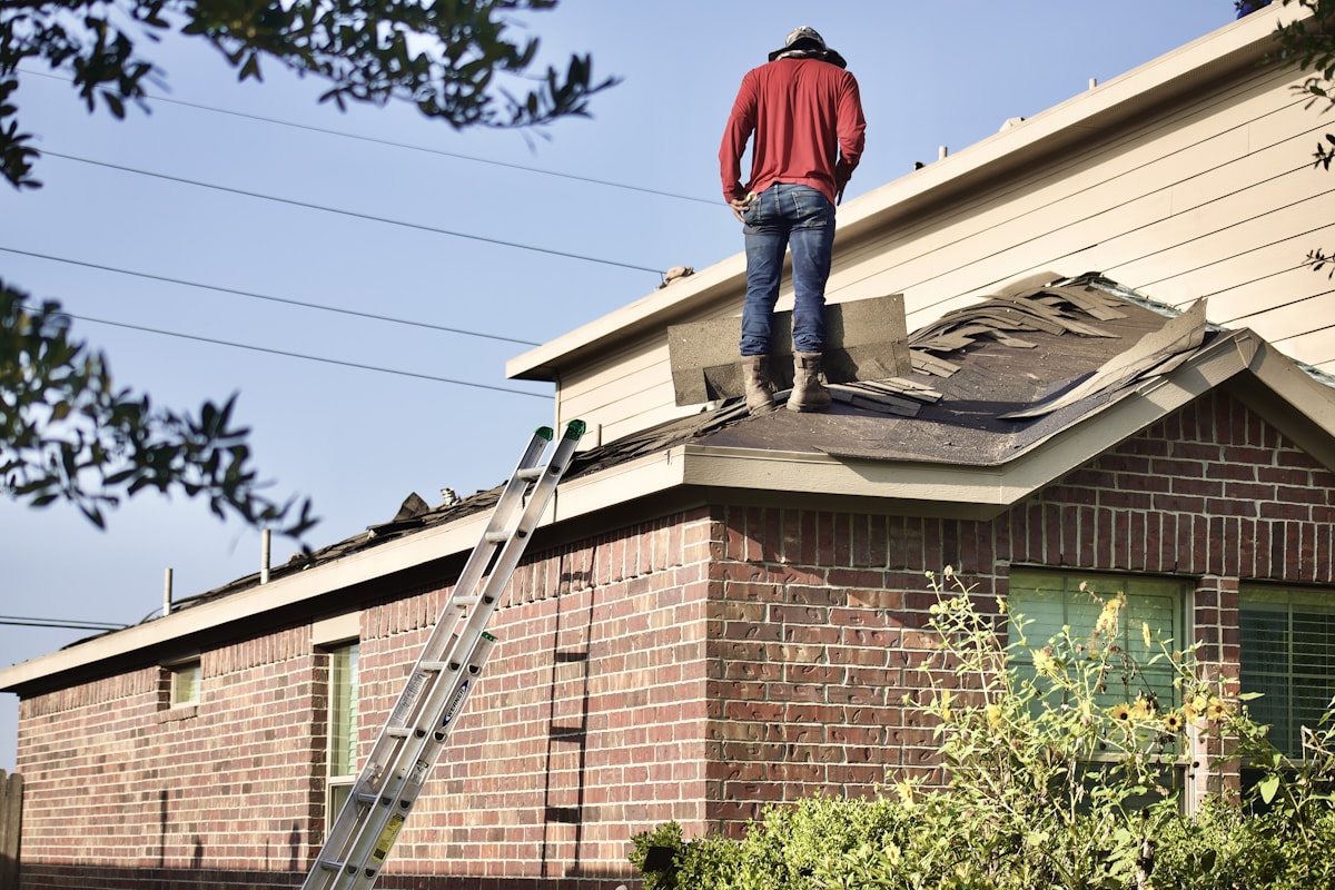 Roofer installing asphalt shingles on a residential roof